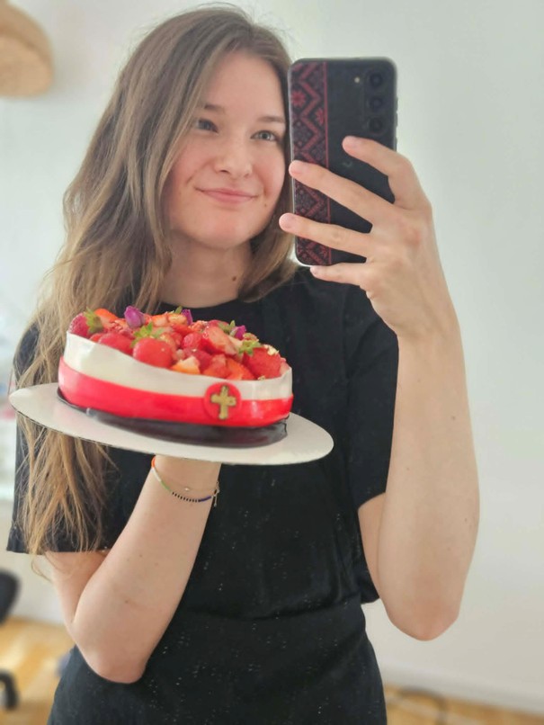 Ella holding one of her cakes