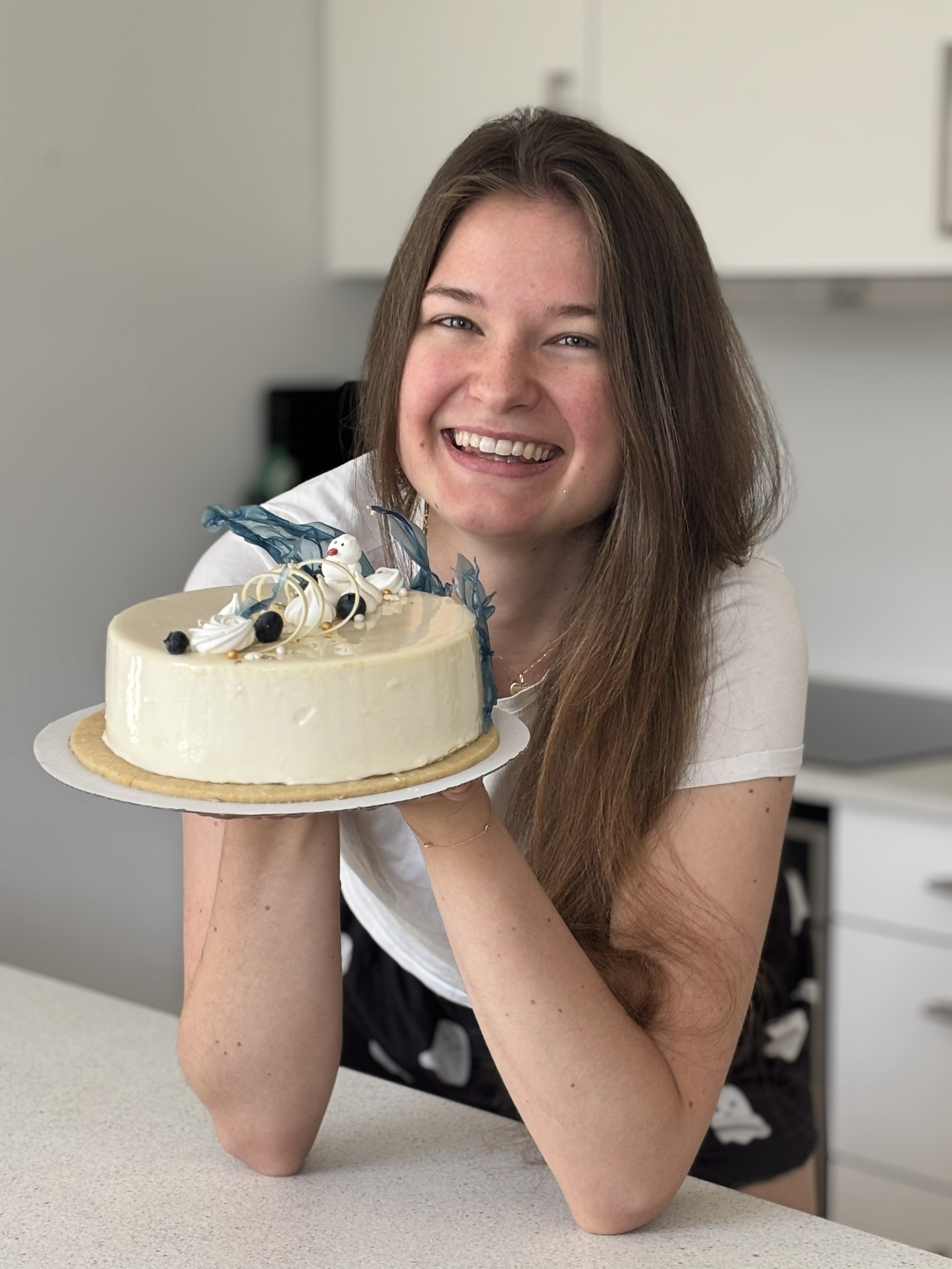 Ella holding one of her cakes